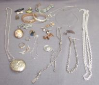 A silver locket on a chain, together with other silver chains,brooches,