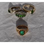An emerald ring set in yellow metal together with a 9ct gold emerald set ring and two other rings