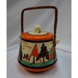 A Clarice Cliff pottery biscuit barrel and cover decorated in the Orange Trees and House pattern,