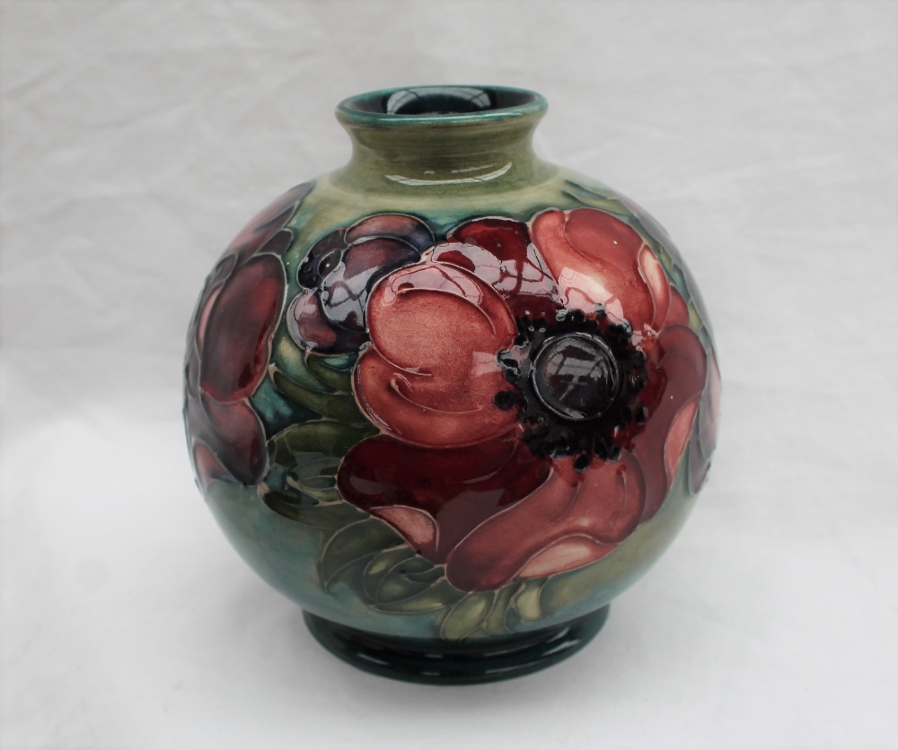 A Moorcroft pottery vase, of globular form decorated in the anemone pattern to a green ground,