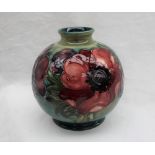A Moorcroft pottery vase, of globular form decorated in the anemone pattern to a green ground,