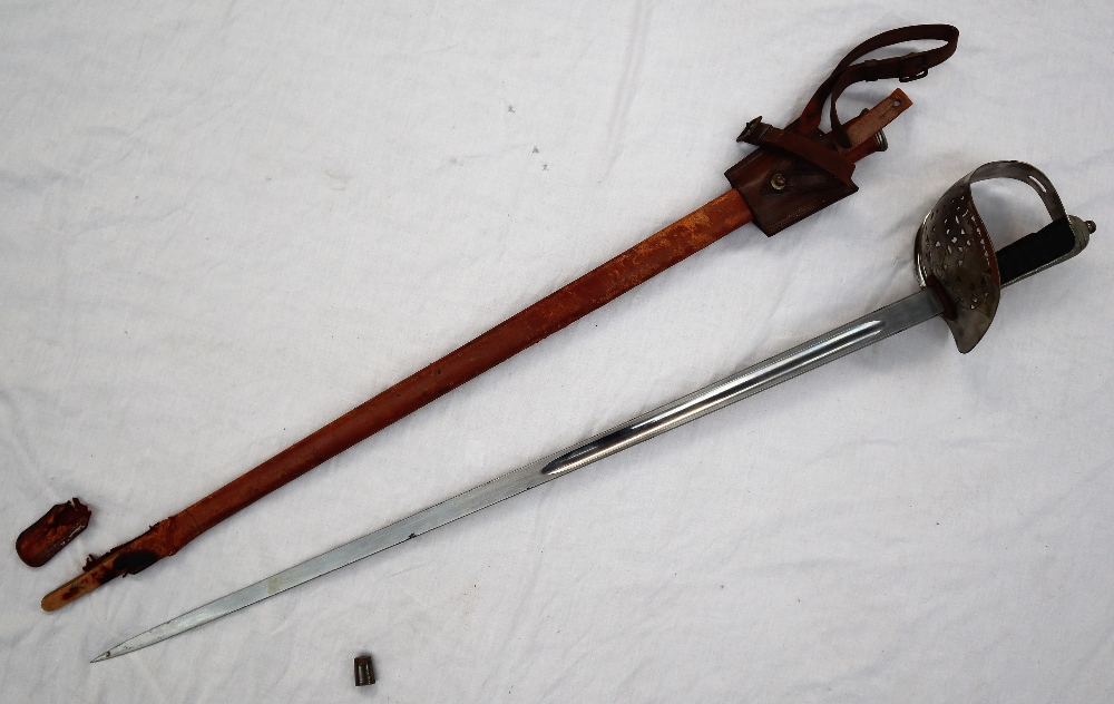 A dress sword with a pierced hand guard and leather grip,