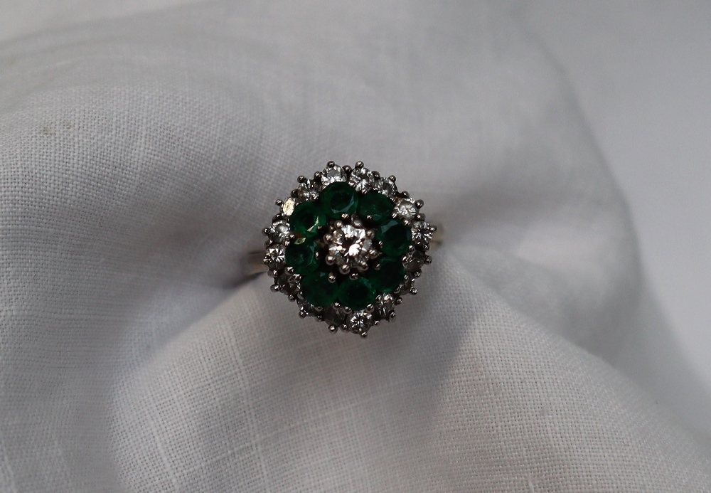 An Emerald and diamond cluster ring, the central round brilliant cut diamond approximately 0. - Image 2 of 5