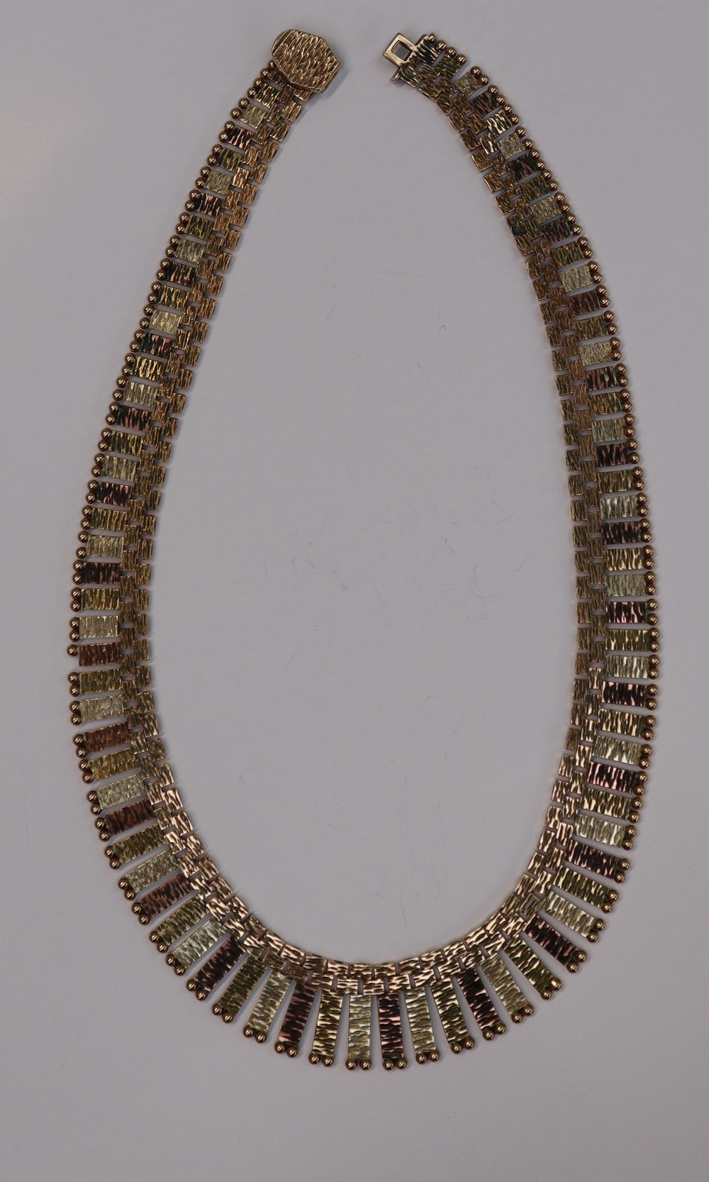 A 9ct yellow and rose gold fringe necklace, with stepped square and rectangular links, 41cm long,