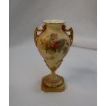 A Royal Worcester porcelain twin handled baluster vase on a spreading foot and square base,