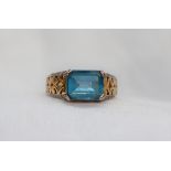 A topaz ring, the emerald cut light blue topaz approximately 10 x 8mm,