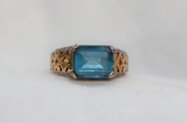 A topaz ring, the emerald cut light blue topaz approximately 10 x 8mm,