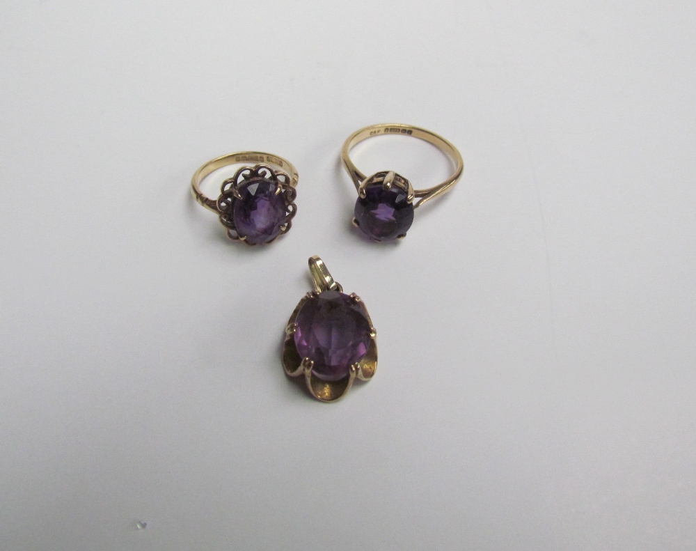 Two 9ct yellow gold amethyst set dress rings together with a yellow metal mounted amethyst pendant