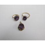 Two 9ct yellow gold amethyst set dress rings together with a yellow metal mounted amethyst pendant