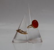 An 18ct gold cornelian set ring, with a cabochon stone set in yellow metal marked 750,