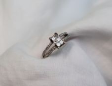 A diamond cluster ring, the centre set with six princess cut diamonds,