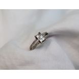 A diamond cluster ring, the centre set with six princess cut diamonds,