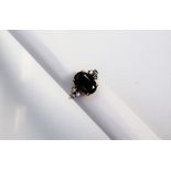 A sapphire and diamond ring, the central oval sapphire, approximately 14 x 9mm,