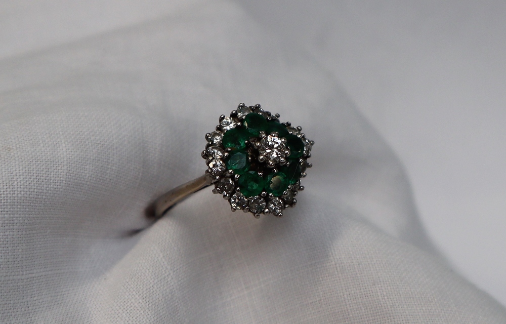 An Emerald and diamond cluster ring, the central round brilliant cut diamond approximately 0. - Image 3 of 5