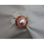 A Mabe pearl ring, to an 18ct yellow gold rockwork setting and shank, approximately 13 grams,