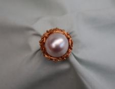 A Mabe pearl ring, to an 18ct yellow gold rockwork setting and shank, approximately 13 grams,