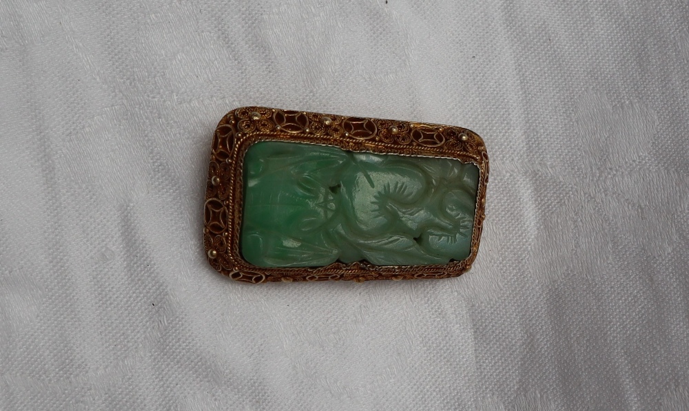 A carved jade panel brooch, to a silver gilt floral scrolling setting, - Image 2 of 4