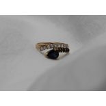 A sapphire and diamond ring, with a pear shaped sapphire and four round faceted sapphires,