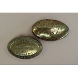 A 19th century oval brass tobacco twist tin, decorated with leaves, stamped W.C.