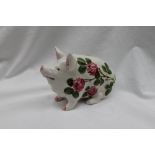 A Wemyss ware seated pig painted with flowers, painted marks Exon 1373 B Adams,