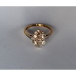 An Edwardian Diamond Dress ring set with round old cut diamonds to a white metal setting and yellow
