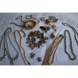 Assorted costume jewellery including bangles, necklaces, charm bracelet,