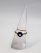 A topaz and diamond ring, the central round faceted topaz, 7mm in diameter,