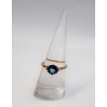 A topaz and diamond ring, the central round faceted topaz, 7mm in diameter,