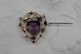 An amethyst and seed pearl brooch of shield shape,