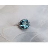 An aquamarine and diamond ring, the central cushion shaped aquamarine approximately 11 x 9mm,