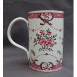 A 19th century Chinese Famille Rose porcelain tankard, decorated with flowers, leaves and swags, 14.