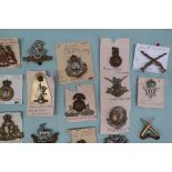 A collection of circa thirty two military cap badges including East Surrey, Duke of Lancasters Own,