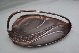 An electroplated WMF dish, of leaf shape with a fixed handle, cast with leaves and fruit, 27cm long.