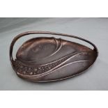 An electroplated WMF dish, of leaf shape with a fixed handle, cast with leaves and fruit, 27cm long.