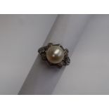 A pearl and diamond dress ring, the central pearl approximately 9mm,