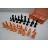 A turned wooden chess set, with weighted pieces, one side ebonised, King 9.5cm high, pawn 4.