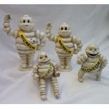 A set of four Michelin Man (Bibendum) cast iron money boxes,