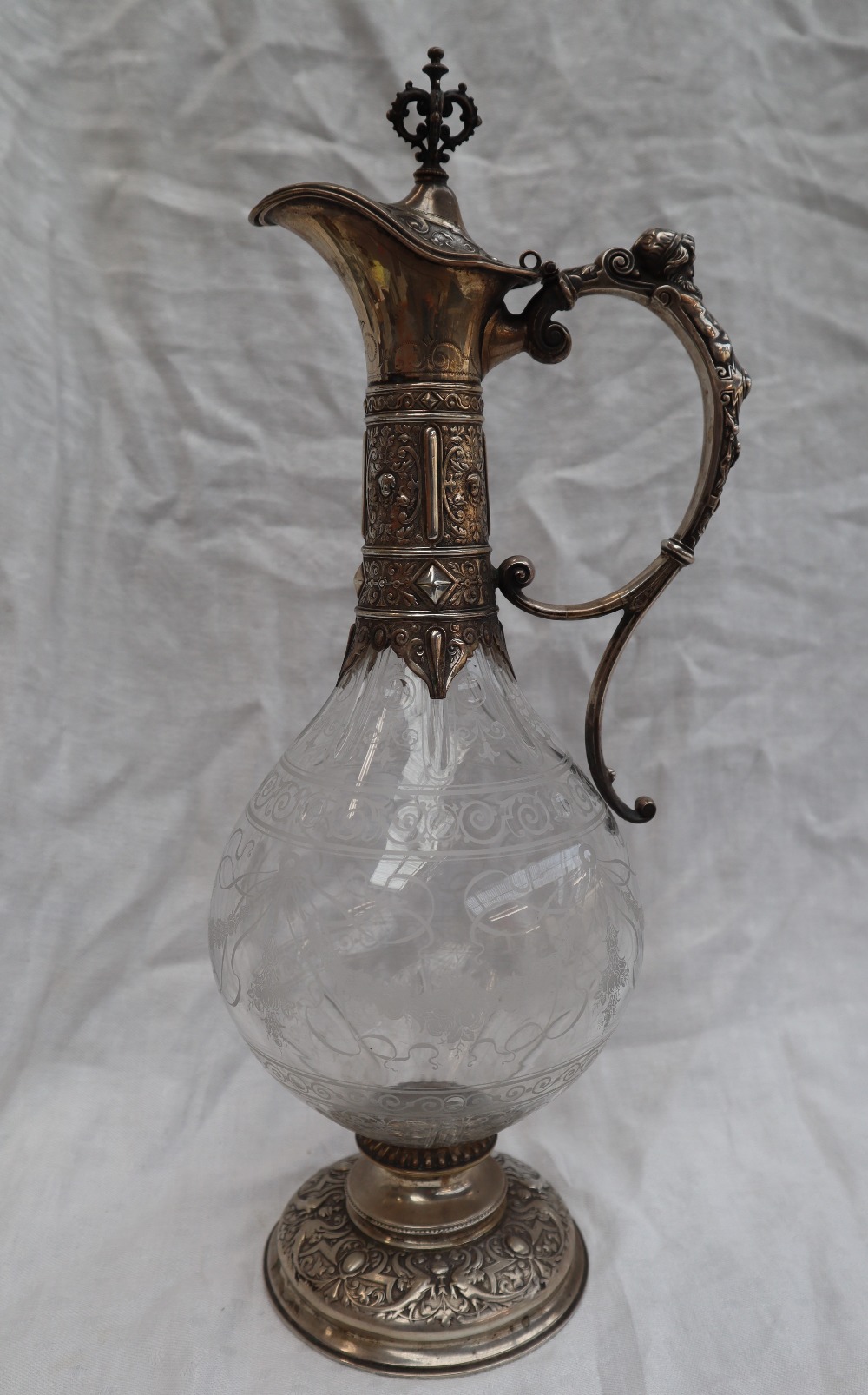 A continental white metal and glass wine ewer,