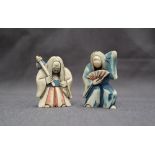A pair of early 20th century Japanese carved ivory figures, with rotating heads,