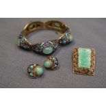 A Chinese white metal, jade and enamel panel bracelet,