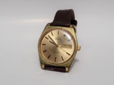 A Gentleman's Omega Geneve automatic wristwatch, the gilt dial with batons and day and date at 3,