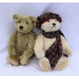 A modern Steiff teddy bear, with a cream mohair articulated body in a tartan hat and scarf,