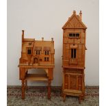 A modern bookcase in the form of a tudor house, with windows and door, enclosing three shelves,