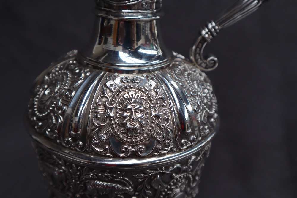 A Victorian silver claret jug, after Cellini, all over decoration of masks and rams, - Image 2 of 13