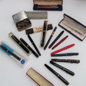A Ronson Penciliter, cased together with a collection of fountain pens including Parker, Summit,