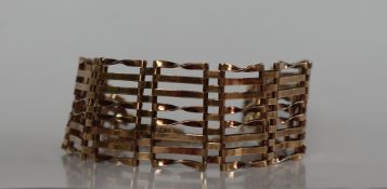 A 9ct yellow gold eight bar bracelet, with a padlock clasp,