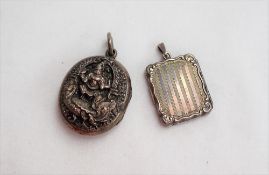 An Indian white metal locket of oval form decorated with a deity together with a continental white