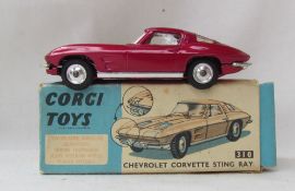 A Corgi Toys diecast model of a Chevrolet Corvette Sting Ray, with a metallic cerise body,