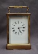 A French brass carriage clock, with a shaped handle and insight platform escapement,