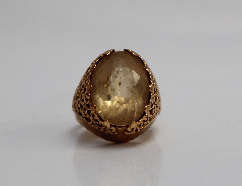 A citrine set dress ring, the oval faceted citrine to a yellow metal setting and shank, - Image 6 of 7